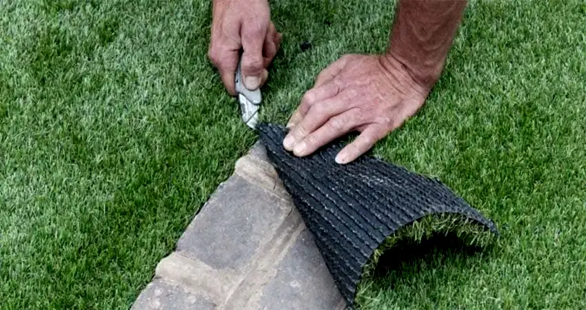 artificial grass being trimmed